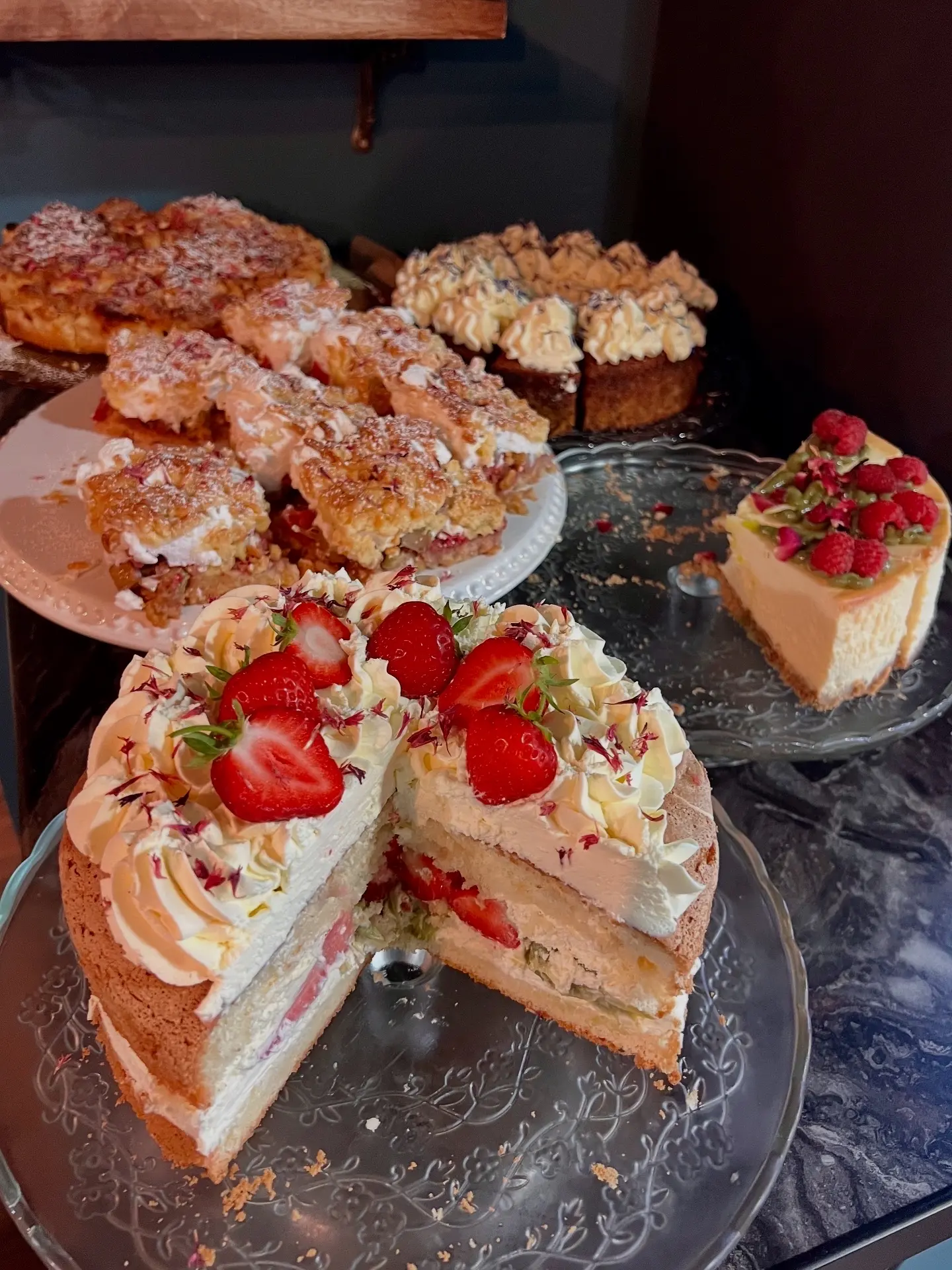Strawberry layer cake with baked goods display