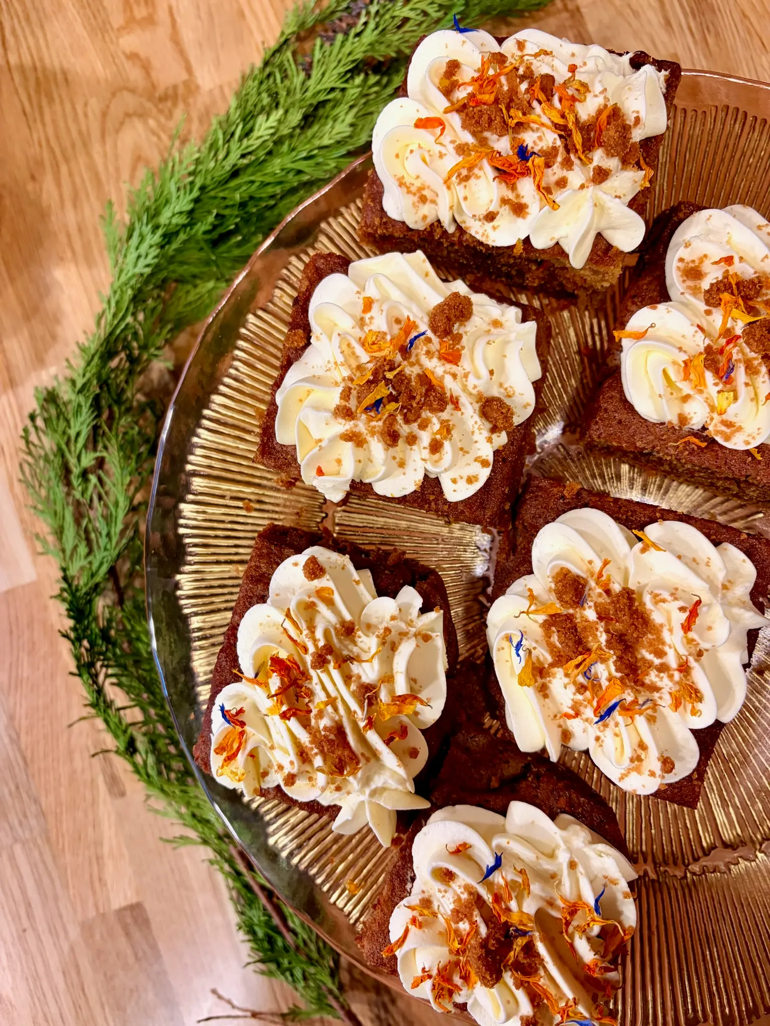 Carrot cake squares with cream cheese frosting and edible flowers