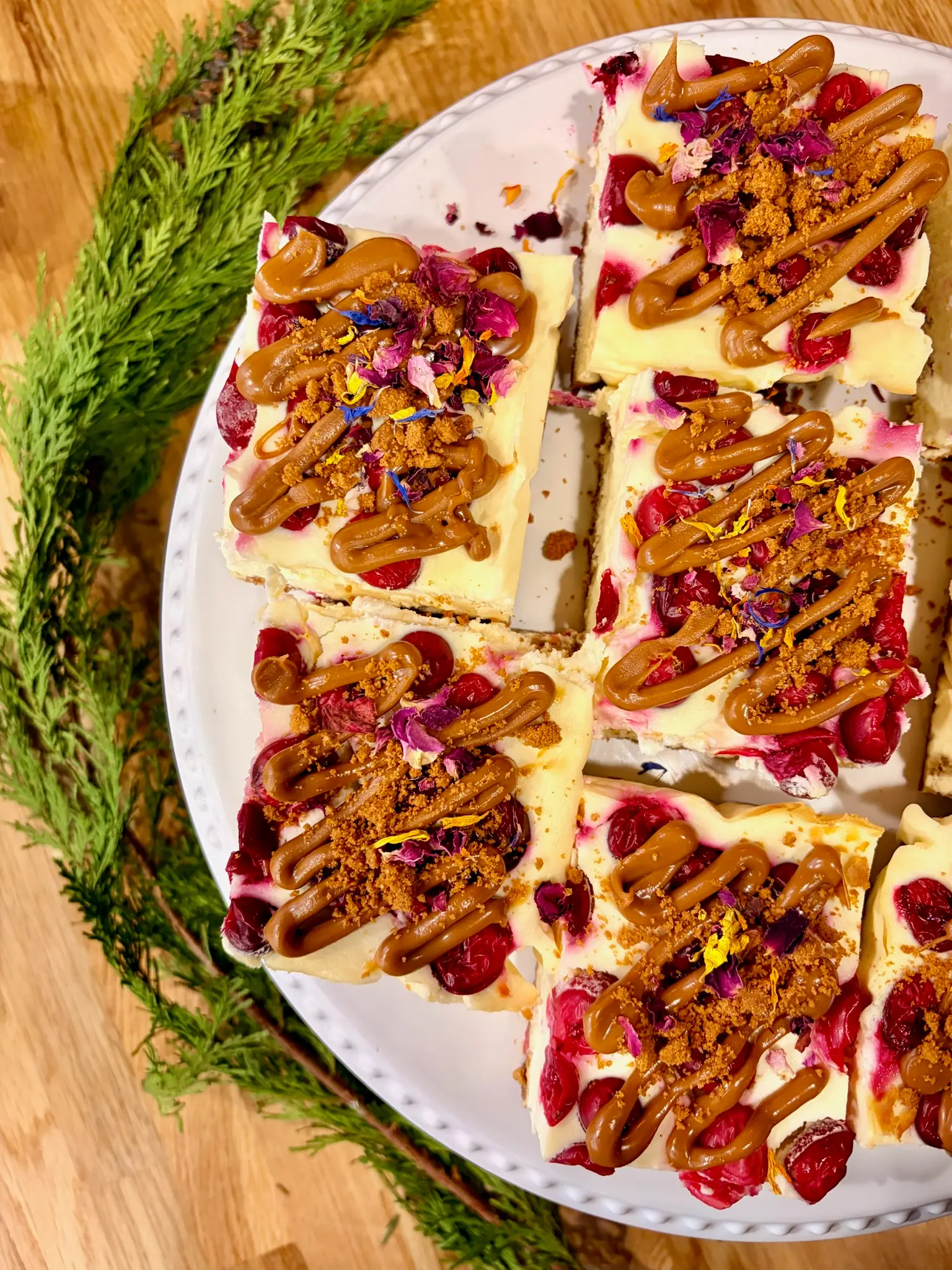 Cranberry biscoff cheesecake slices with caramel drizzle