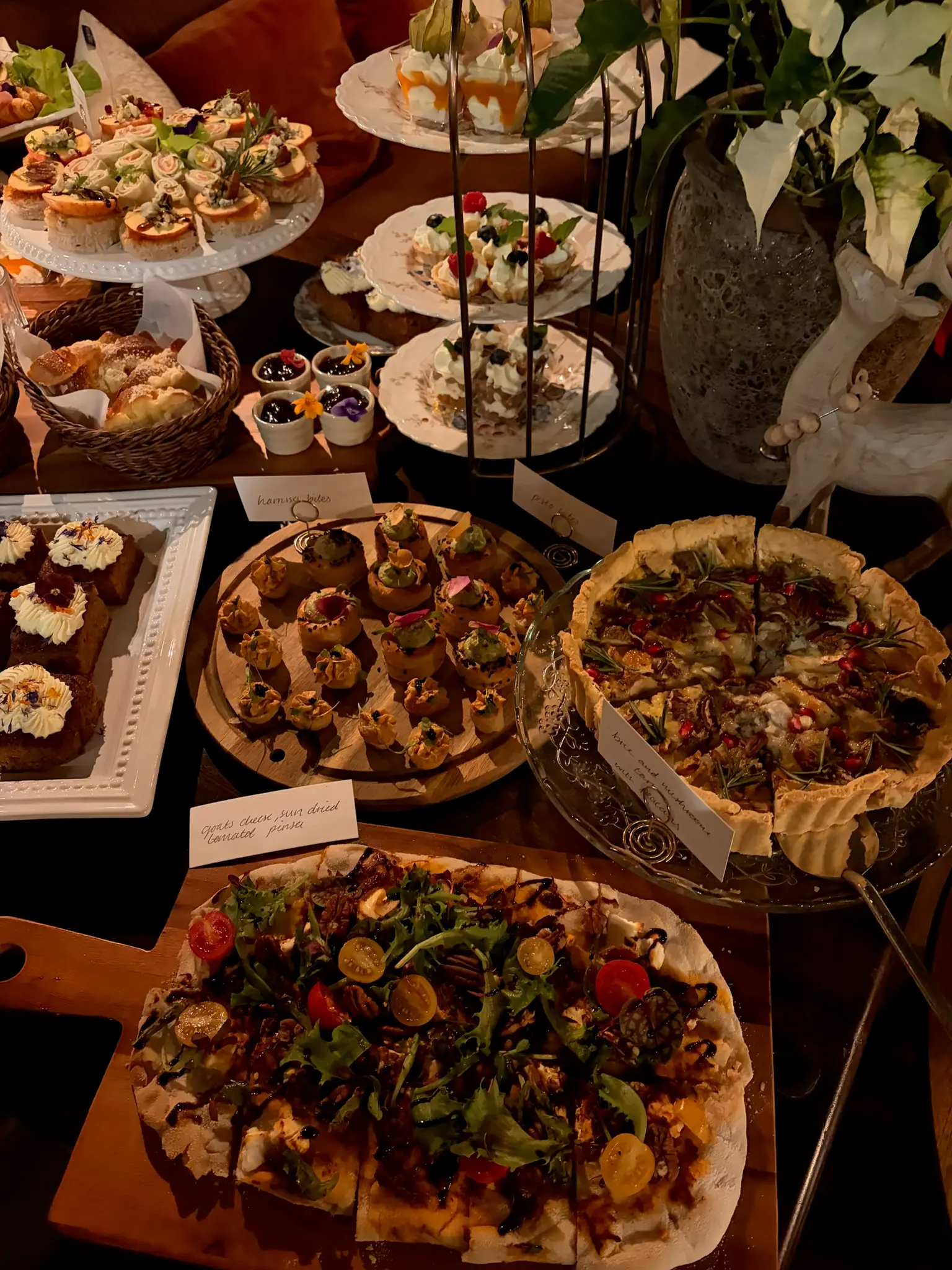 Grazing table spread with flatbreads, canapés and pastries