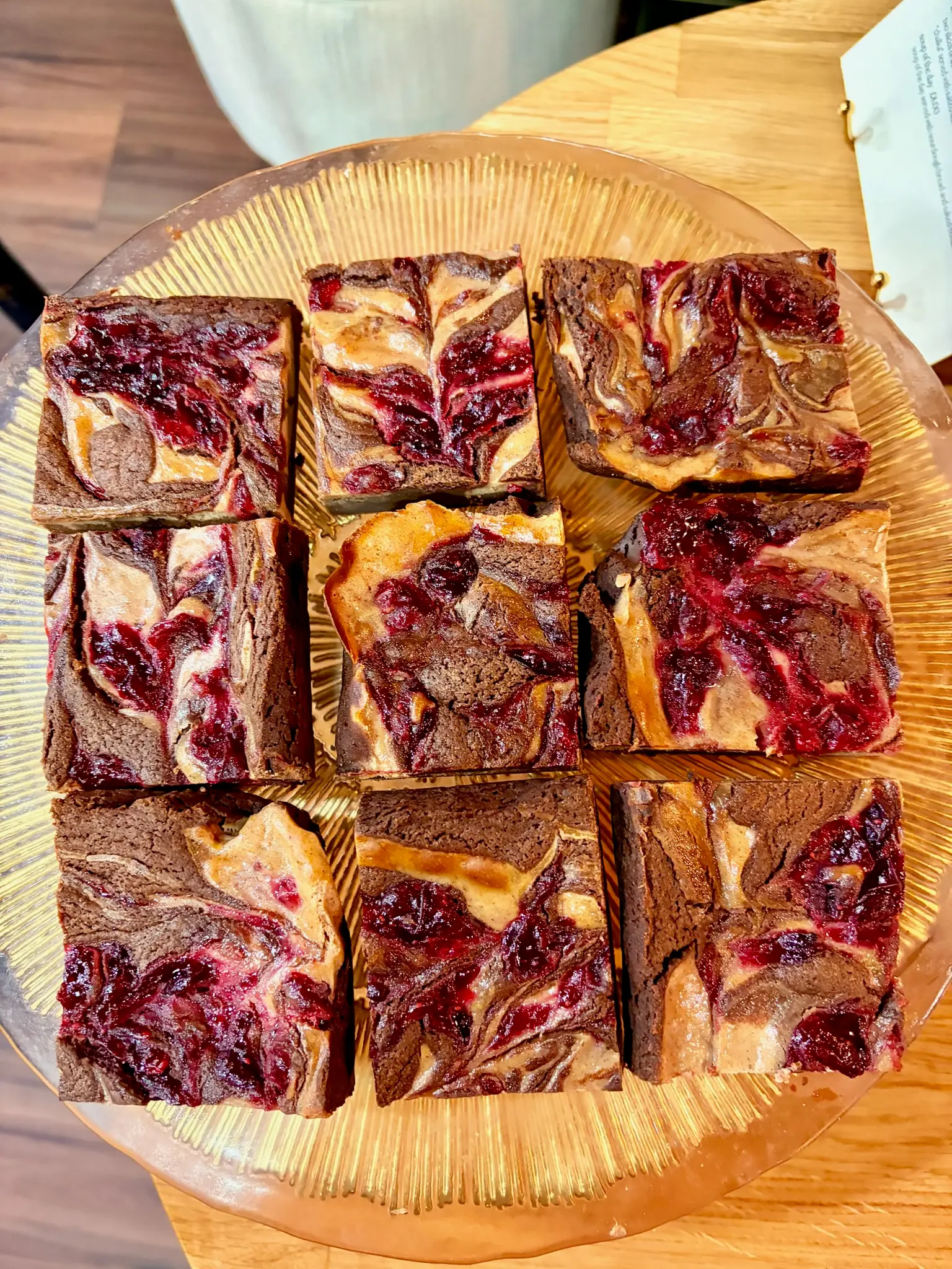 Raspberry cheesecake brownies on a gold plate