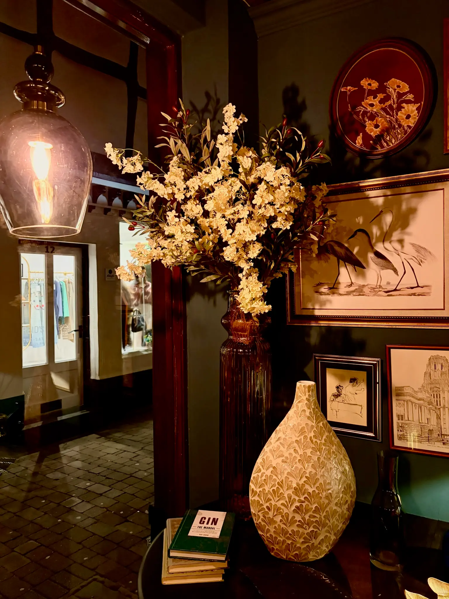 Entrance hallway with blossom arrangement and framed vintage art