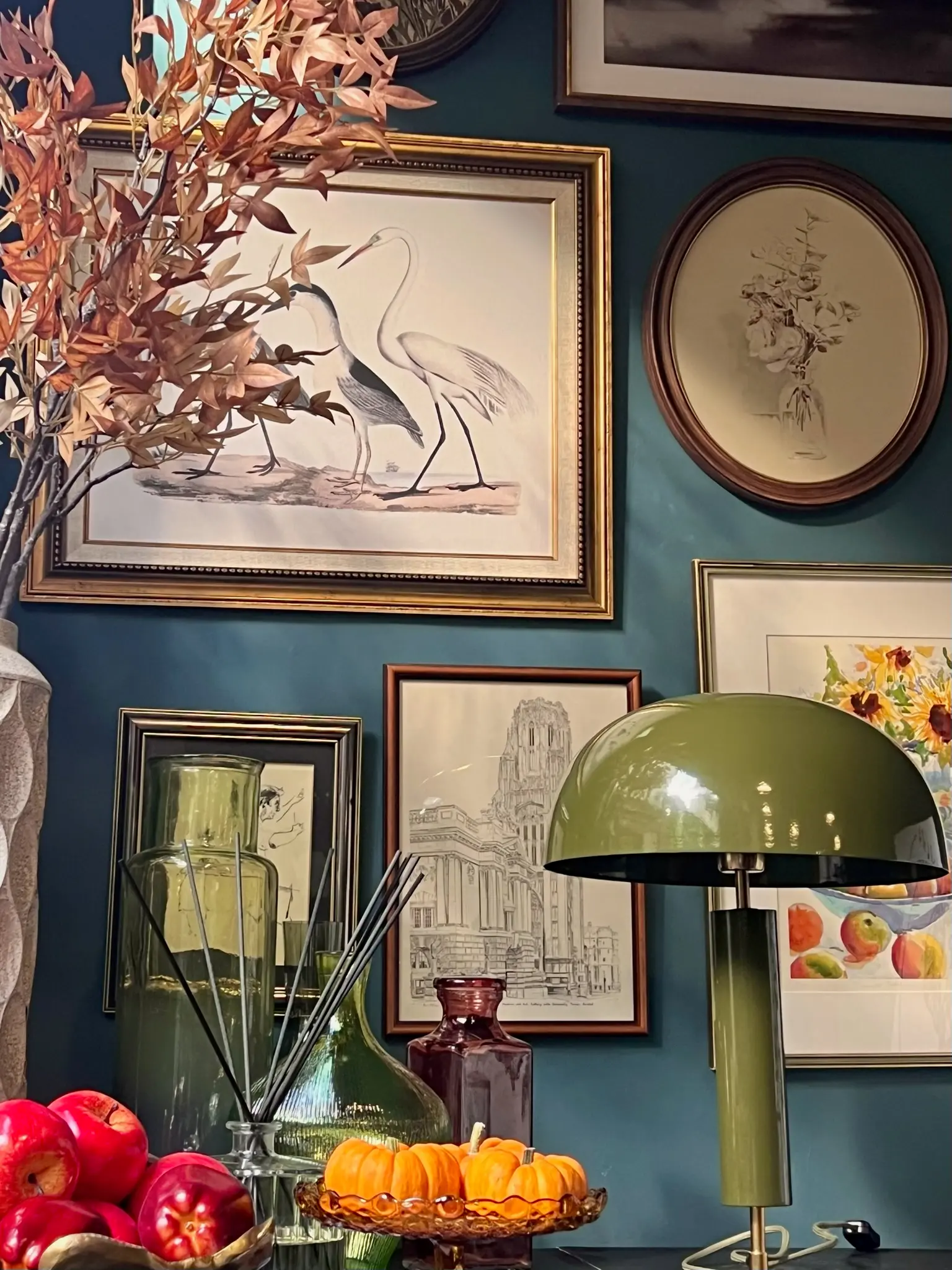Vintage gallery wall with heron prints on a teal backdrop