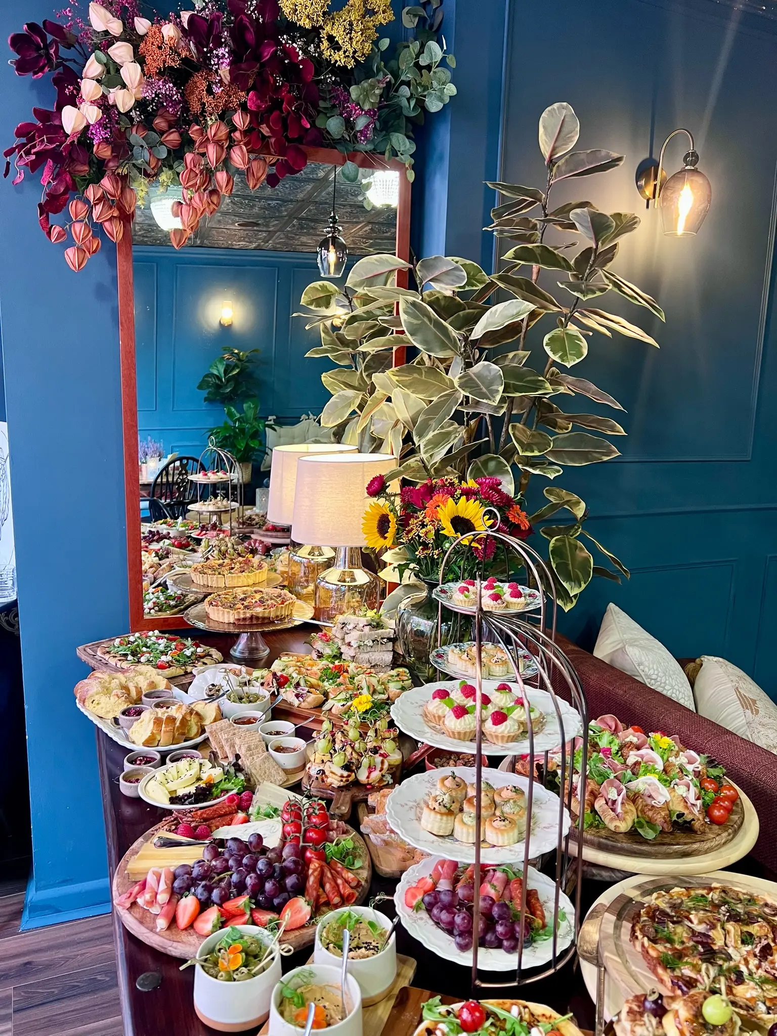 Grand brunch buffet table with floral centrepiece and tiered stands