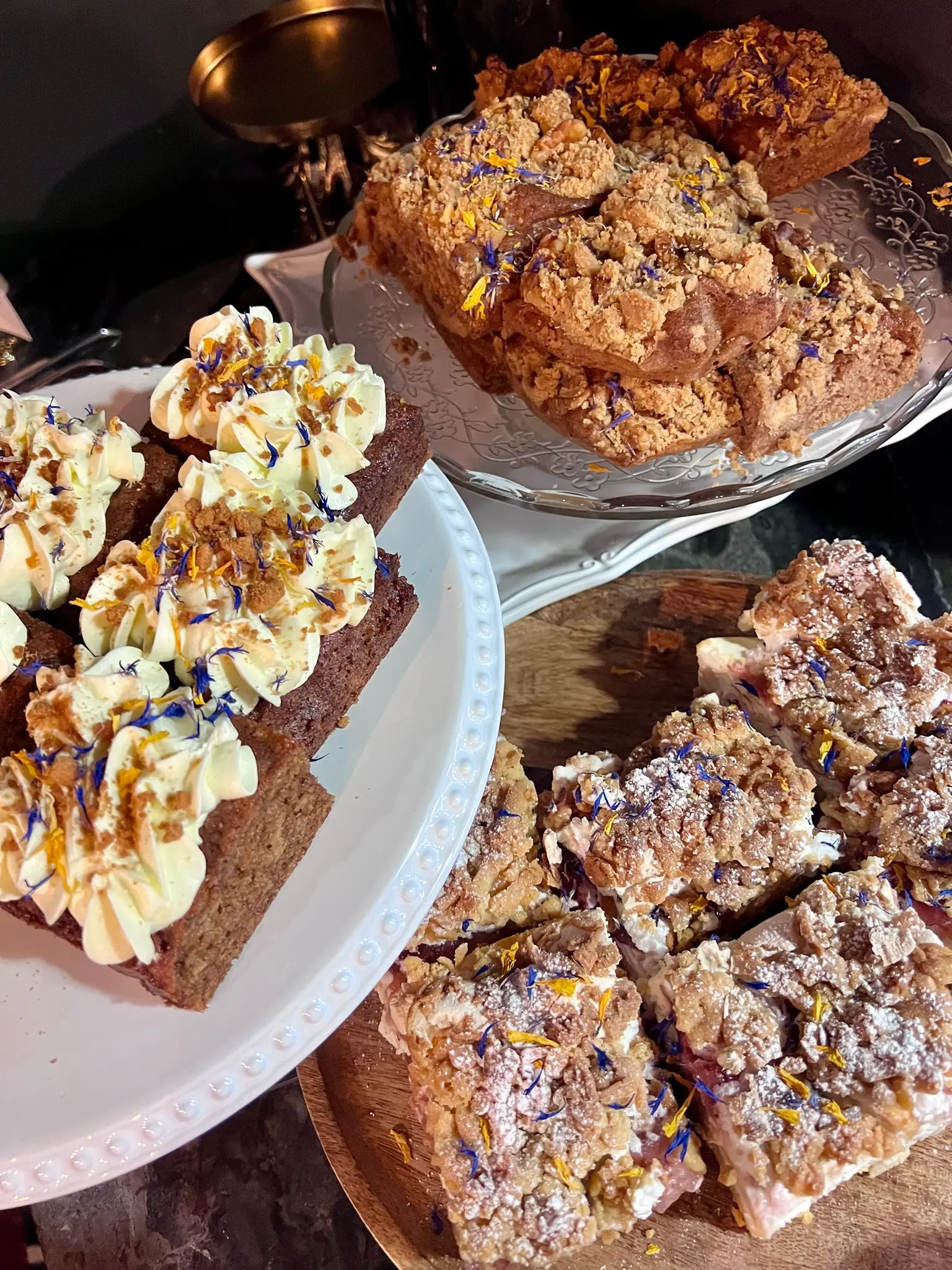 Assorted baked goods including carrot cake and crumble bars
